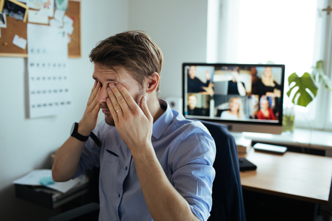 employee rubs eyes after video conferencing call